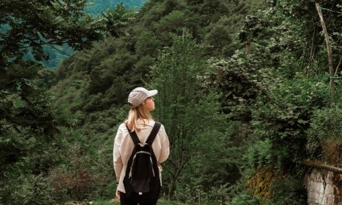 May Blog woman walking through trail